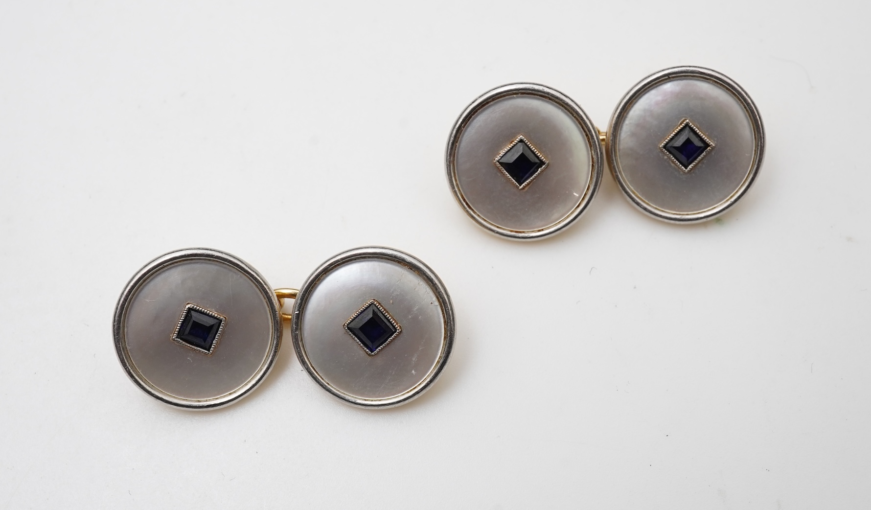 A pair of mother of pearl and sapphire cufflinks, early 20th century